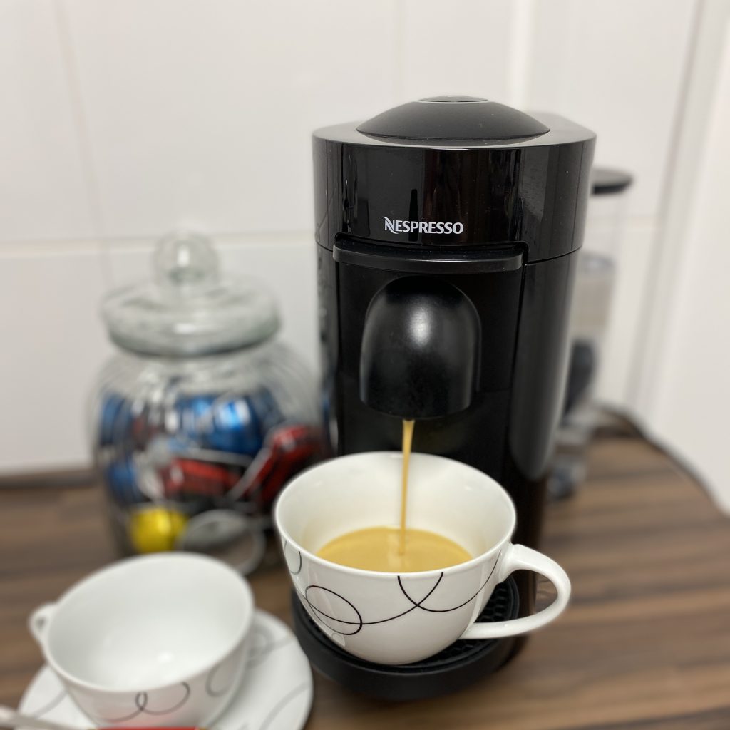 Nespresso coffee machine dispensing coffee into a cup