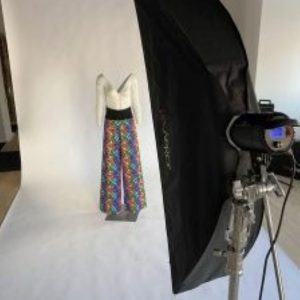 Mannequin wearing trousers on white photographic backdrop with professional photography light