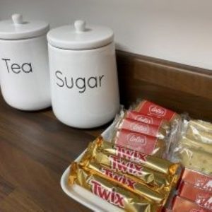 Tea and sugar canisters with chocolate biscuits