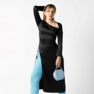 Professional model wearing black dress, blue leggings and blue handbag