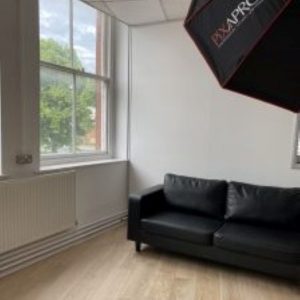 Contemporary black sofa, window, professional Pixapro photographic light